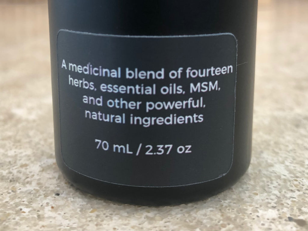 Close-up of The Formula for Pain back label listing fourteen herbs, essential oils, and MSM, 70 mL / 2.37 oz